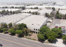 An industrial building sits among many