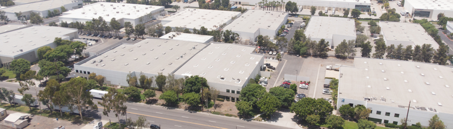 An industrial building sits among many