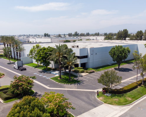 An industrial building sits among many